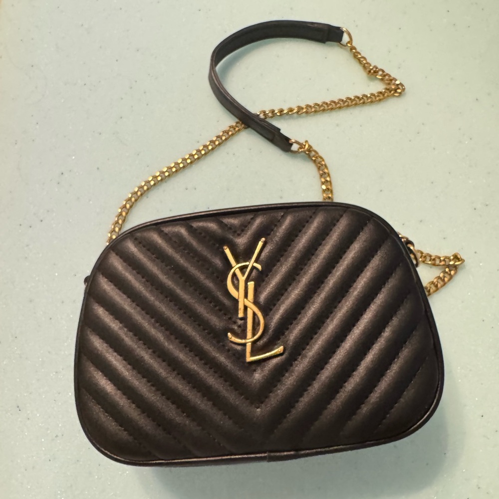 Knockoff ysl. Minor scratching to metal. Leather in perfect condition